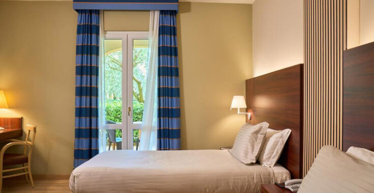 Deluxe twin room bedroom at Delfina Palace Hotel